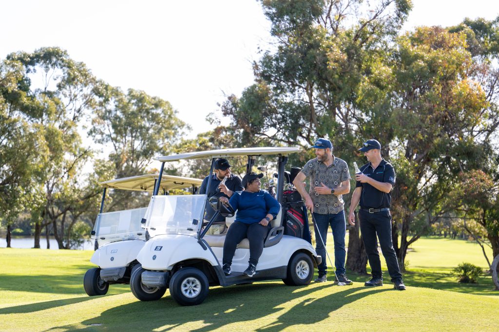 Golfers with a golf cart enjoying beers and talking