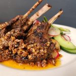 Picture of 3 lamb ribs on salad with potato